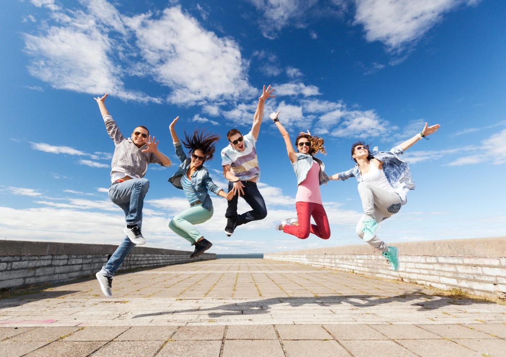 group of teenagers jumping for a photo